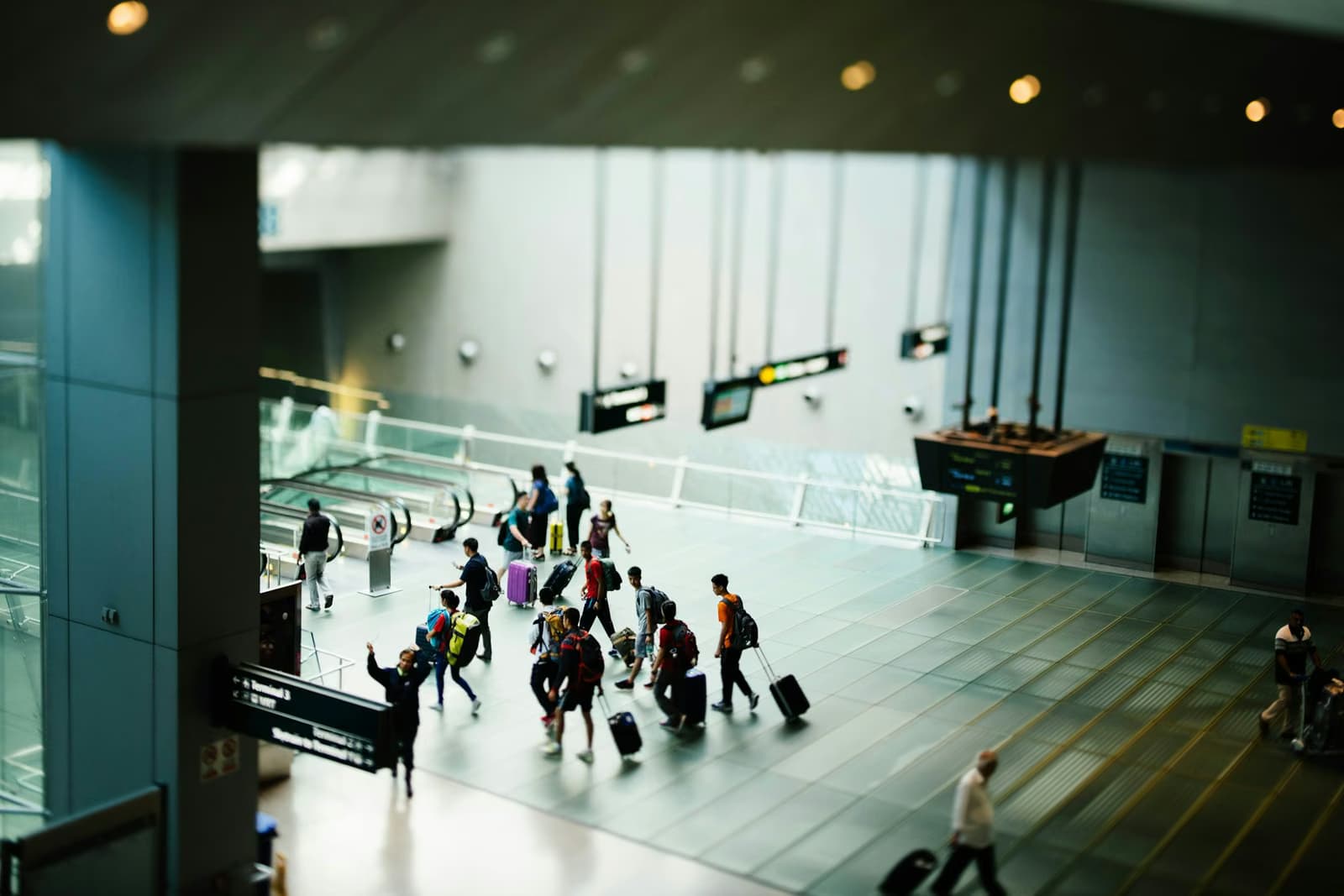 Travelers with suitcases in an airport terminal